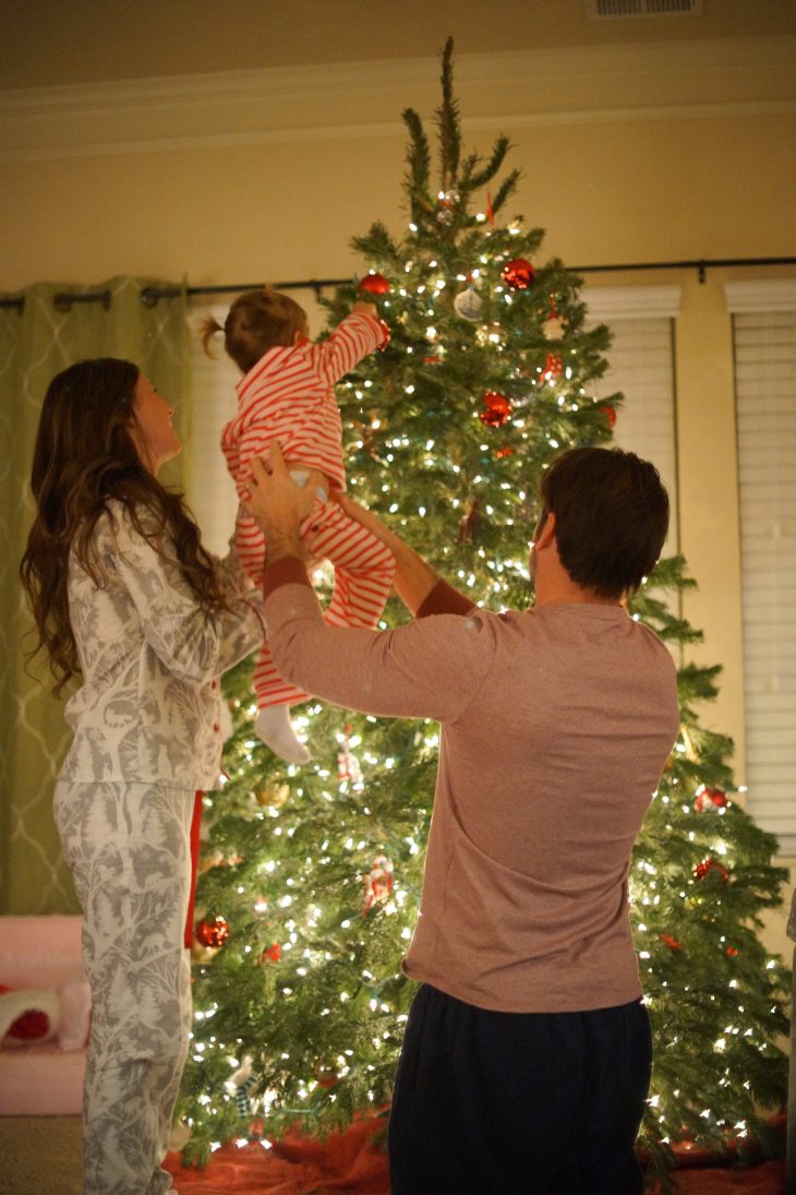 Non traditional christmas pajamas for the family not matching decorating the christmas tree