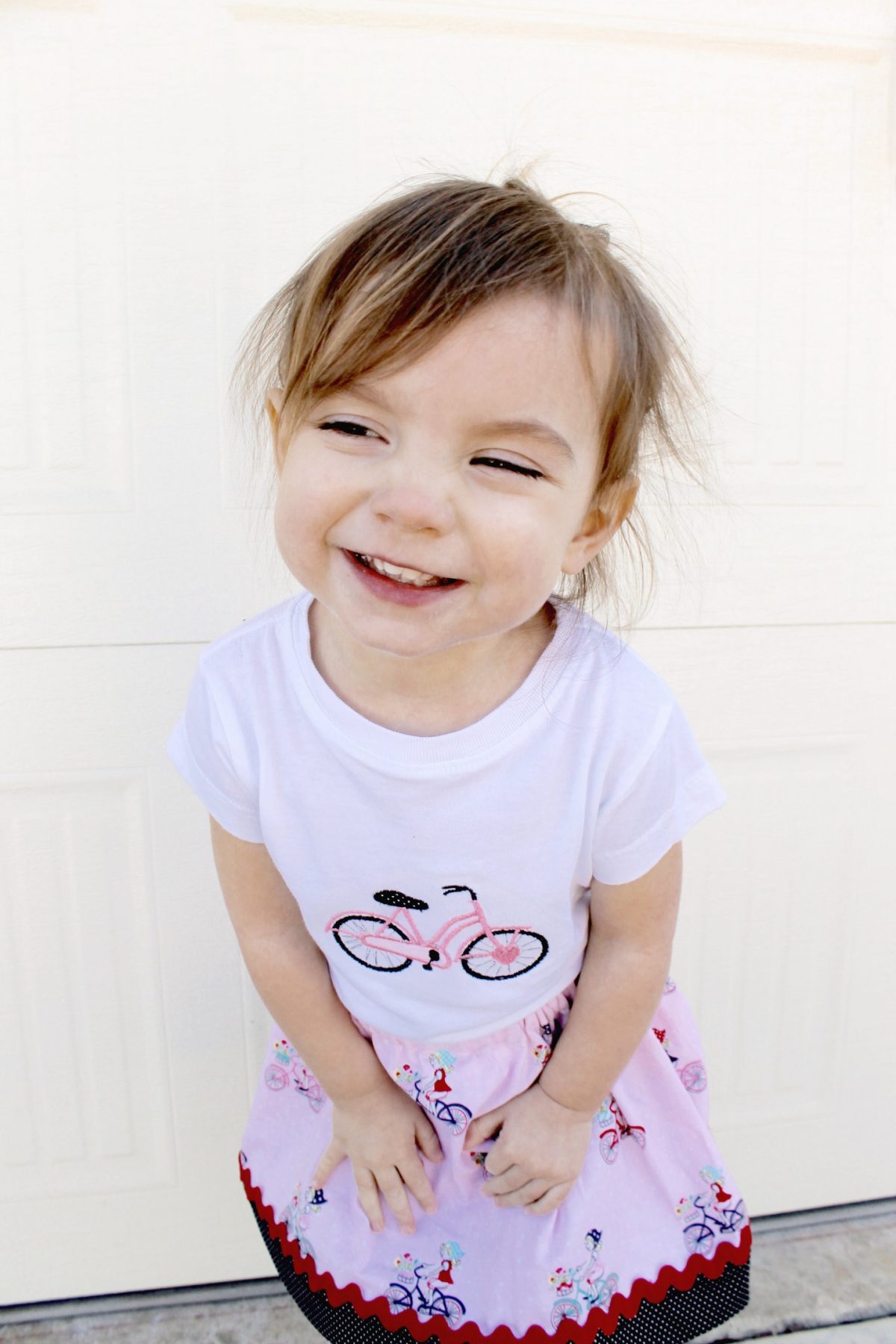 Little Girl wearing bicycle shirt and smiling toddler's favorite things