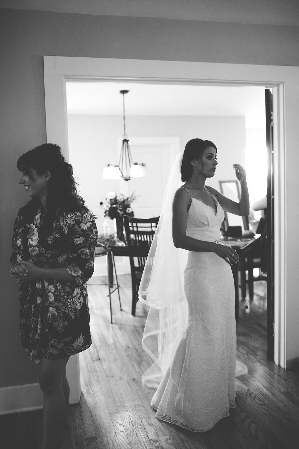 Black and White Photo Bride in Gown and Bridesmaid in Floral Robe