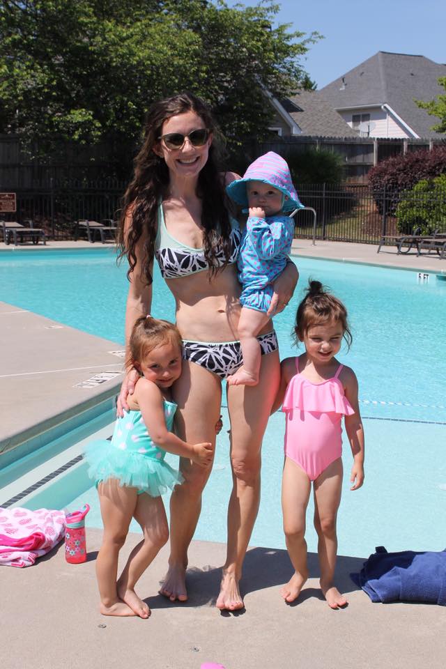 Mom and kids at the pool in the summer sun