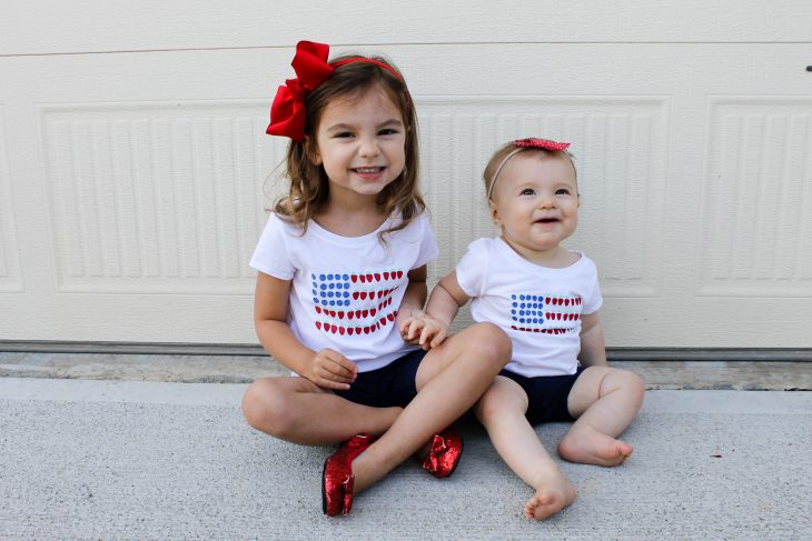 Sisters wearing fourth of July outfits celebrating First Fourth of July together