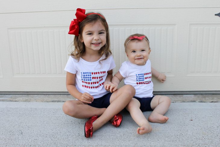 Sisters wearing fourth of July outfits celebrating First Fourth of July together