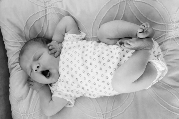 black and white photo newborn yawning
