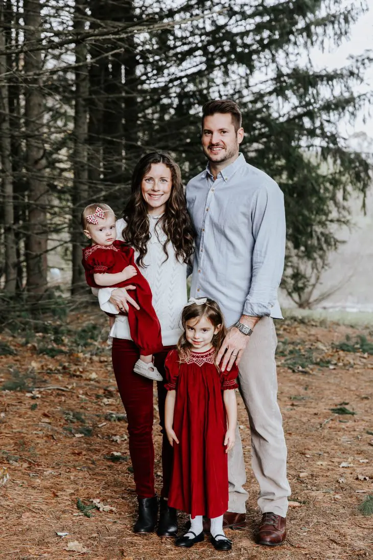 Portrait of happy family posing near Christmas tree Stock Photo - Alamy