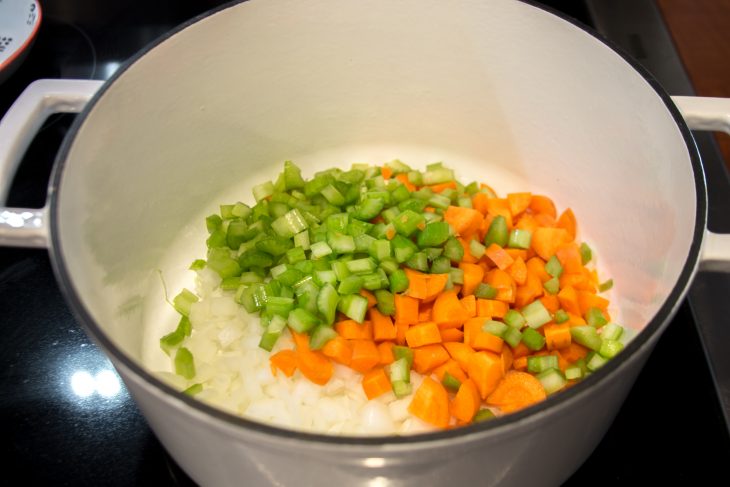 Celery, carrots, and onions cooking in soup pot