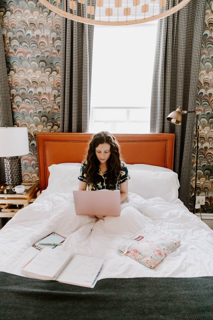 Girl working on laptop in bed