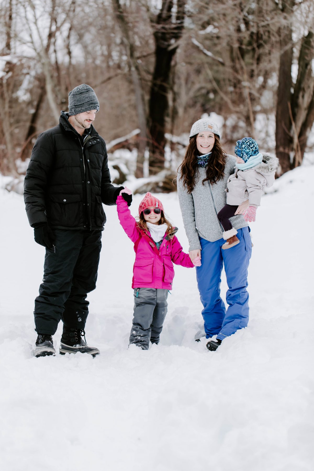 family in snow pants in snow