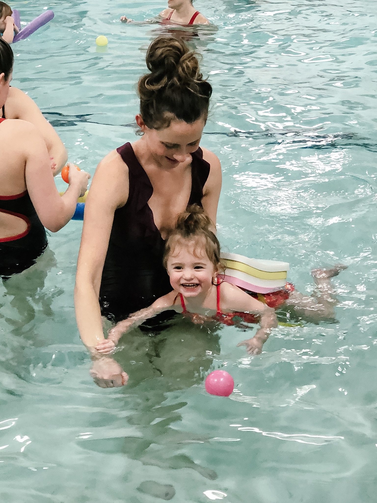 Mom and Daughter Swimming in Pool