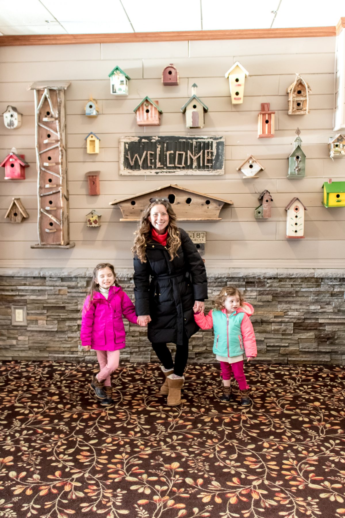 Mom and Daughters standing in main dining room at Woodloch