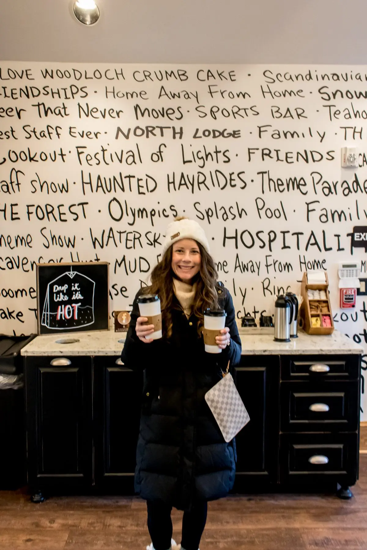 Woman holding two coffees at Gigi's Coffee House Woodloch Pines Pocono Mountains