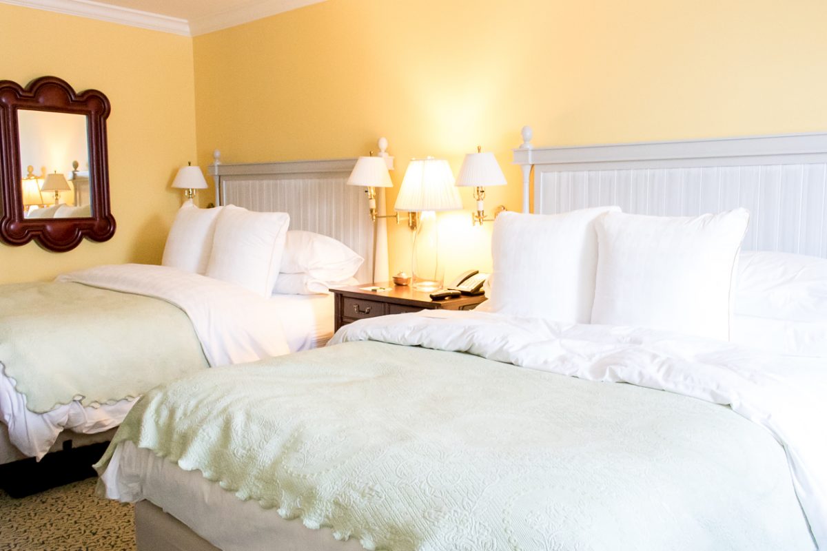 Queen Size Beds with Yellow Walls at Woodstock Inn and Resort in Woodstock Vermont