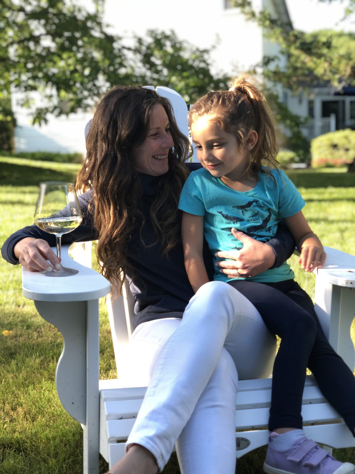 Mom and Daughter sitting in white Adirondack Chair 