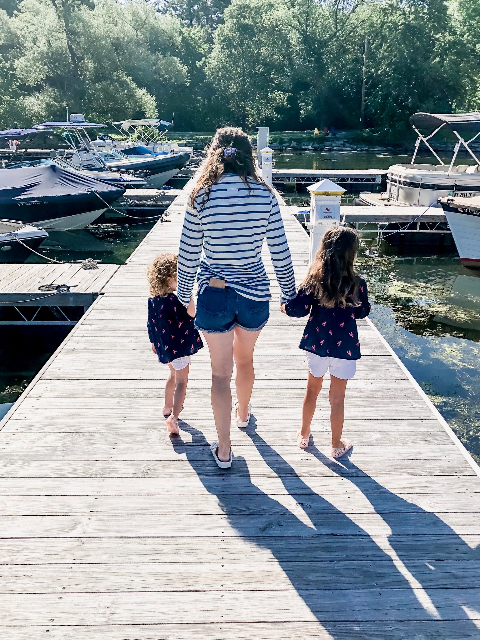 Mom and Daughters walking on lake dock in Basin Harbor