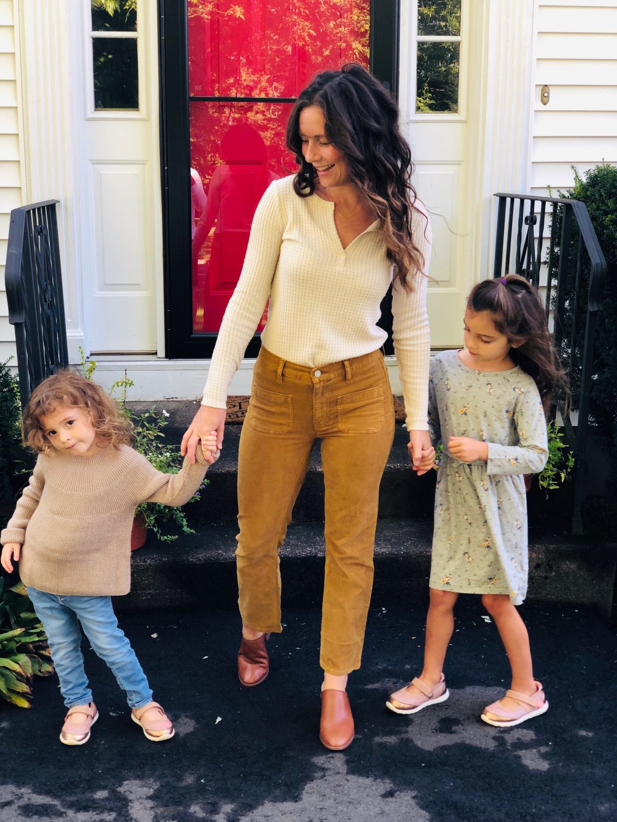 Woman wearing Cropped Corduroy Denim, Waffle Henley, Leather Mules with two little girls