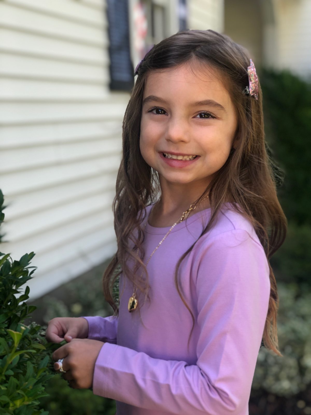Little girl wearing purple dress heart locket necklace kindergarten update