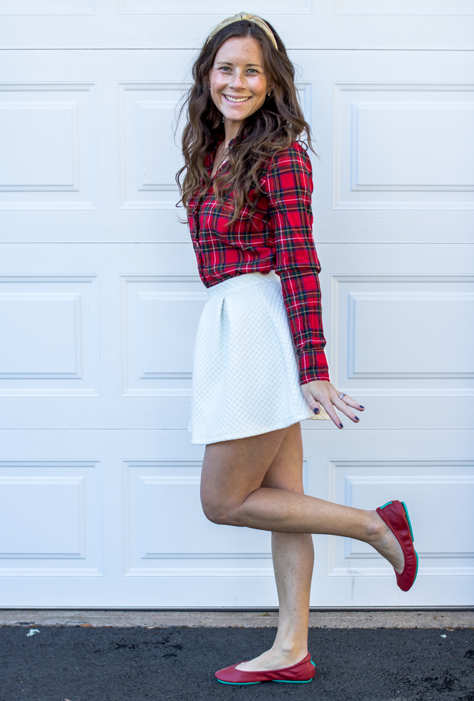 girl in red plaid shirt with white skirt wearing red tieks