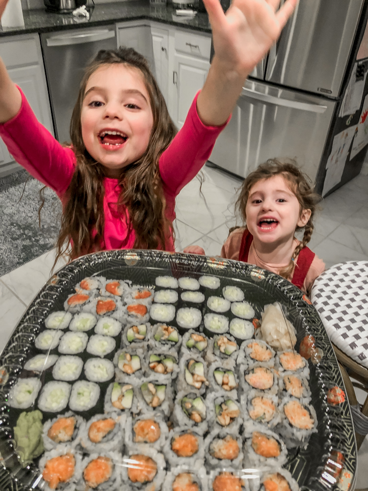 little girls cheering as they look at sushi