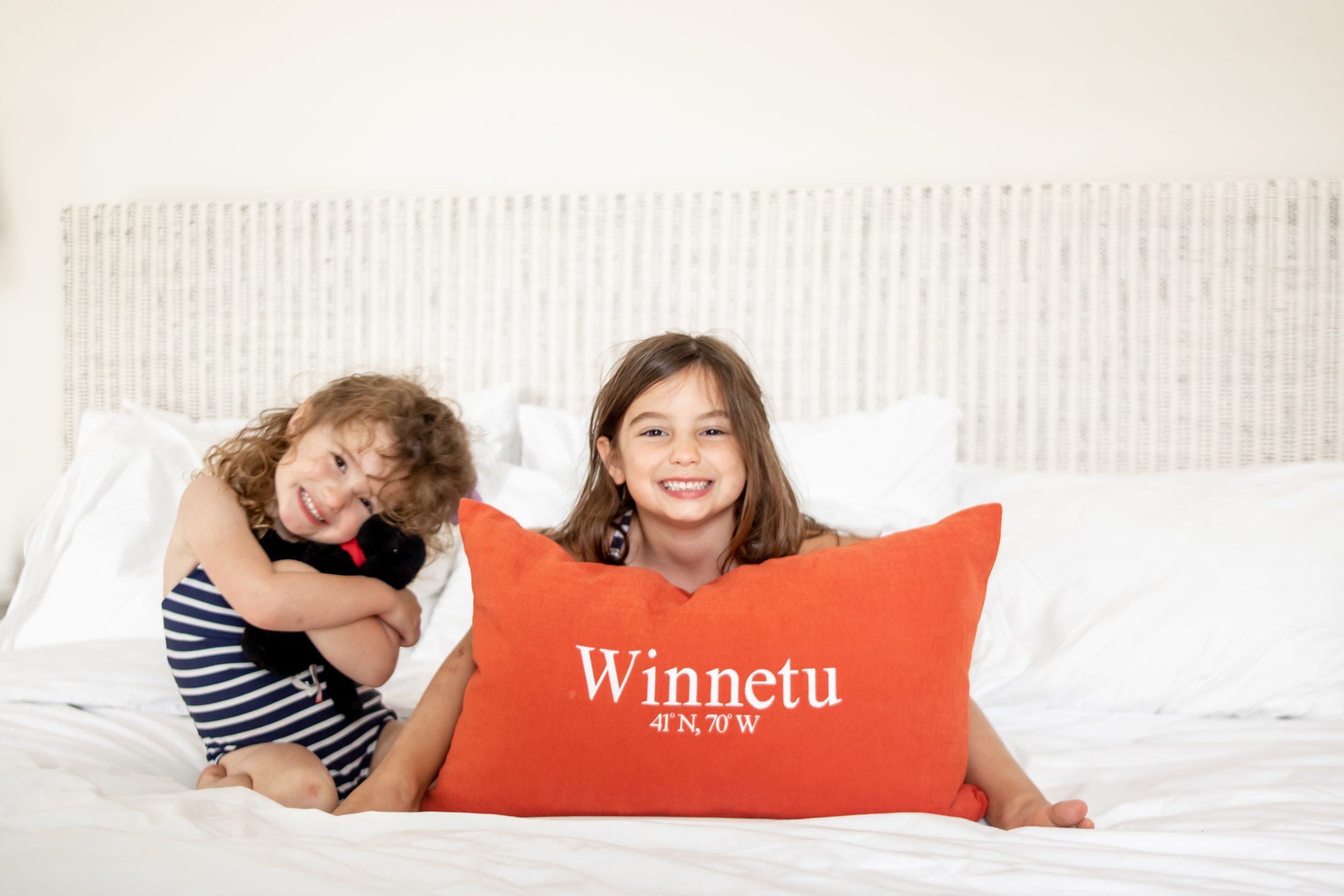 little kids sitting on bed at Winnetu Oceanside Resort