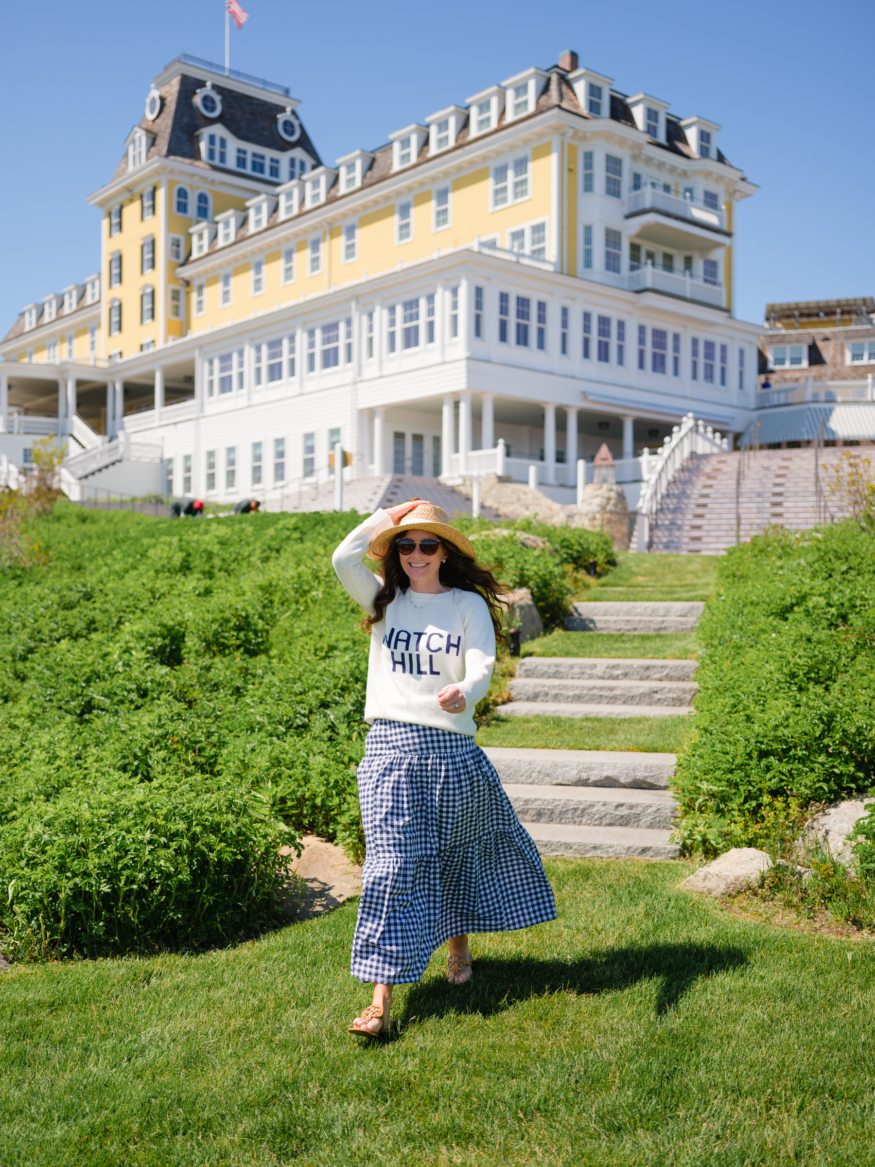 woman walking down stairs at Ocean House RI in Watch Hill Sweater and Gingham Skirt loving lately