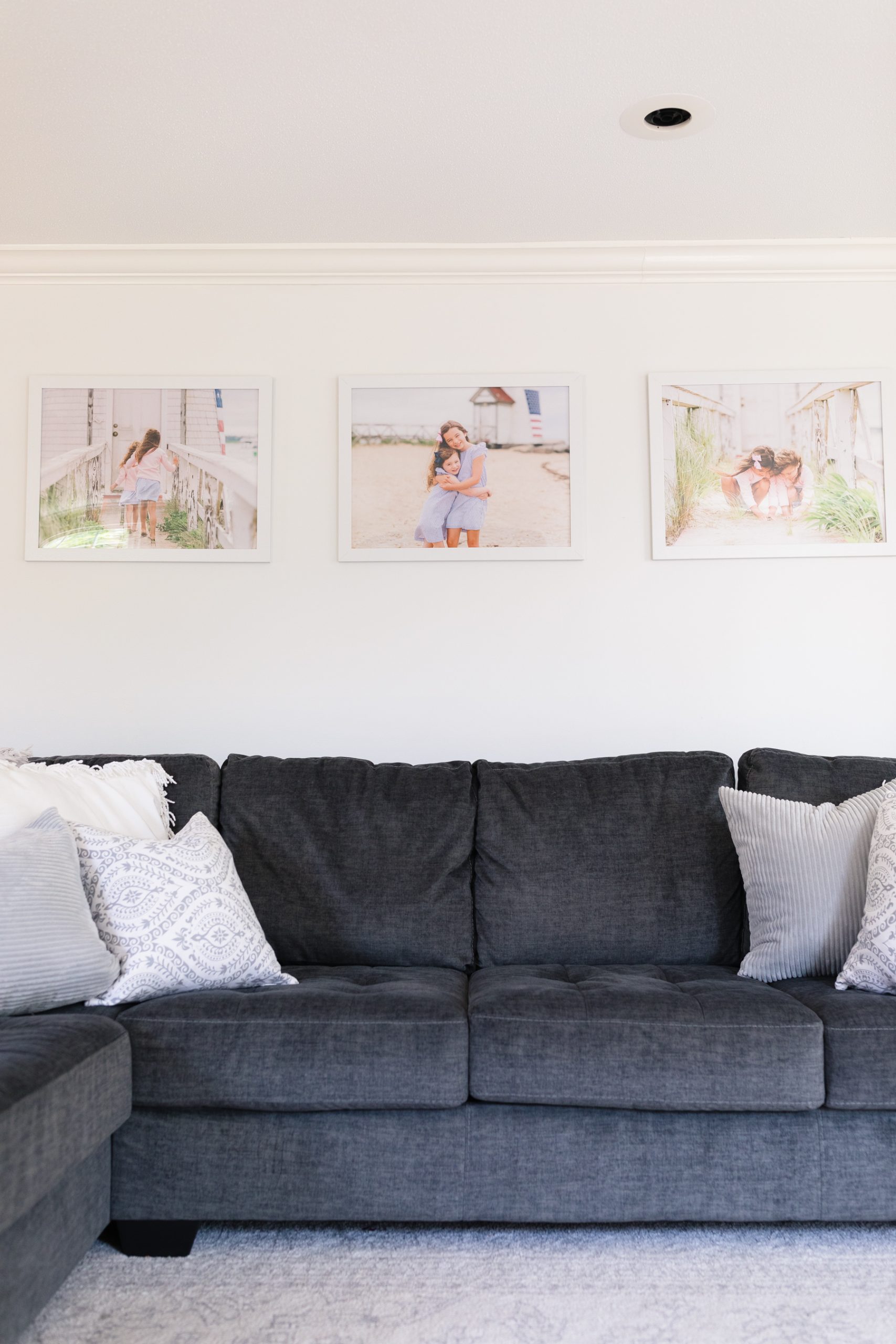 three enlarged prints hanging on wall above couch