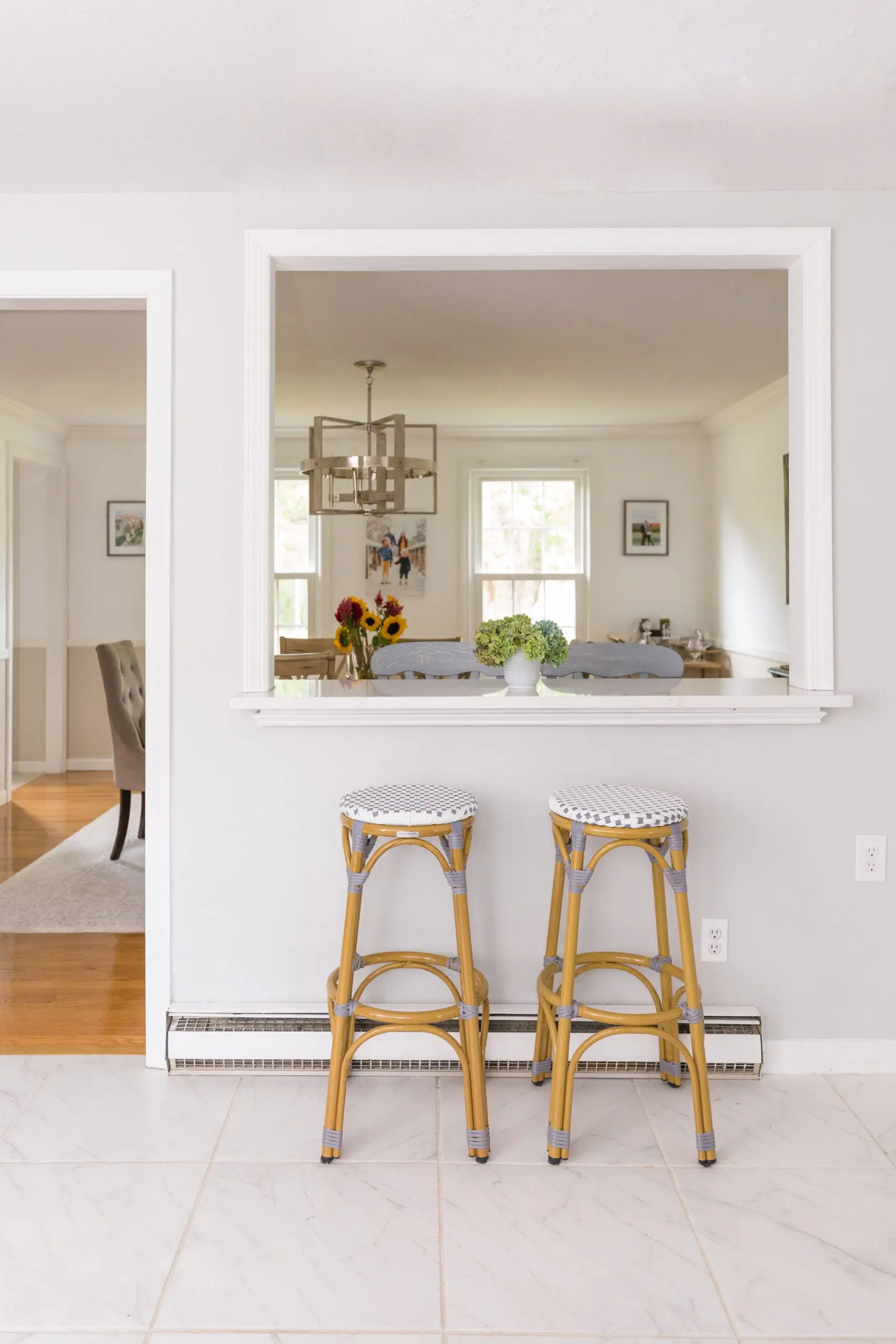 Breakfast Bar with white quartz countertop in kitchen with serena lily riviera dupe stools 