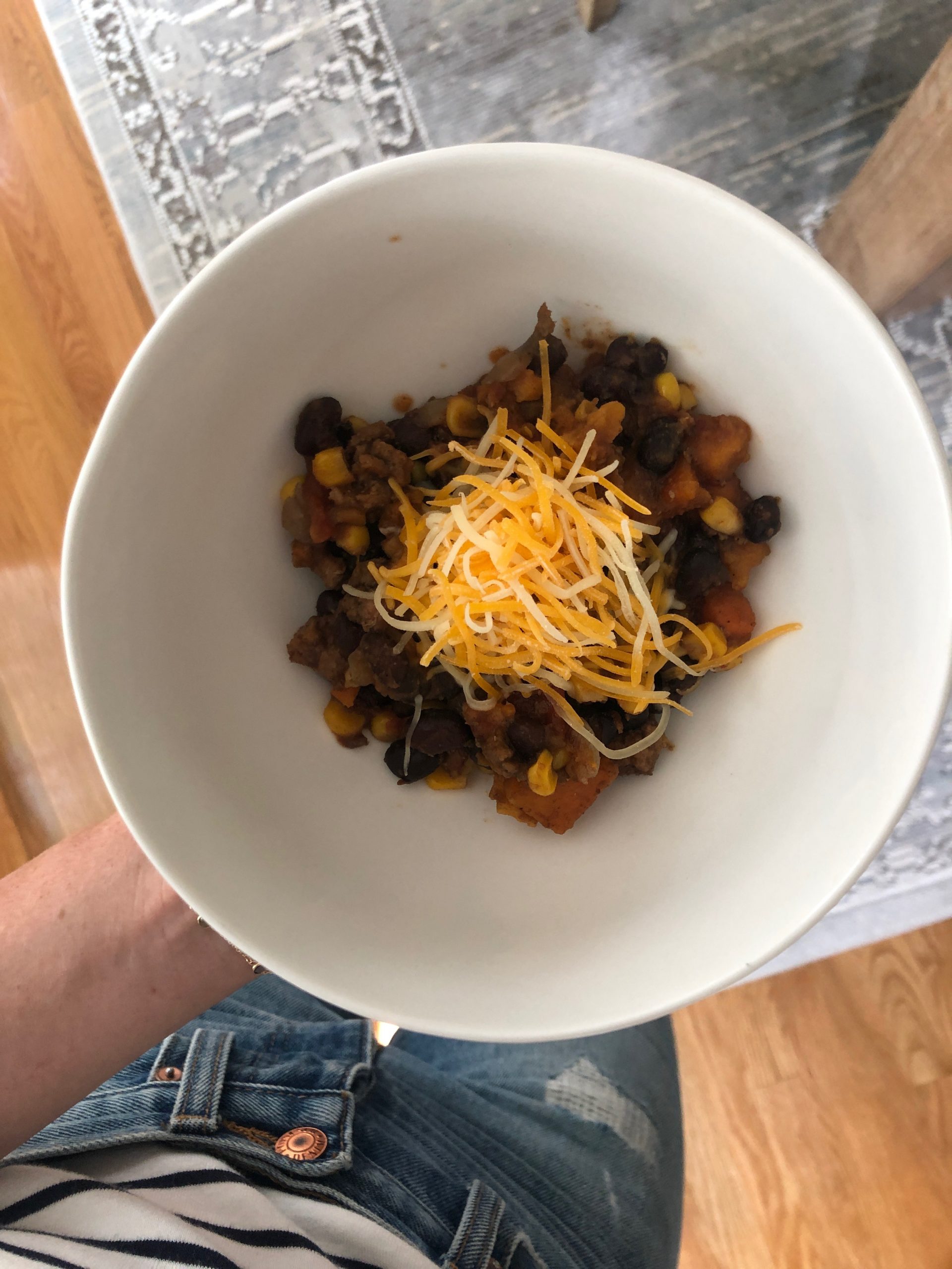 Sweet Potato Black Bean Turkey Chili topped with shredded cheese 