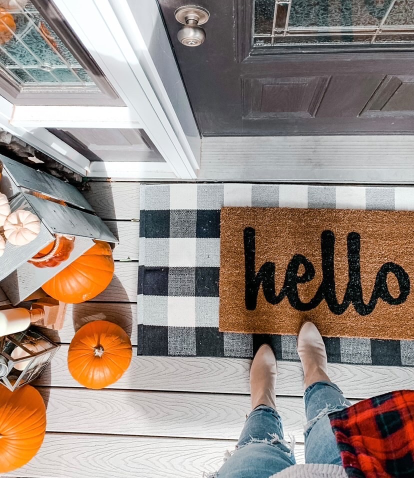 Fall front porch with gingham mat and hello mat