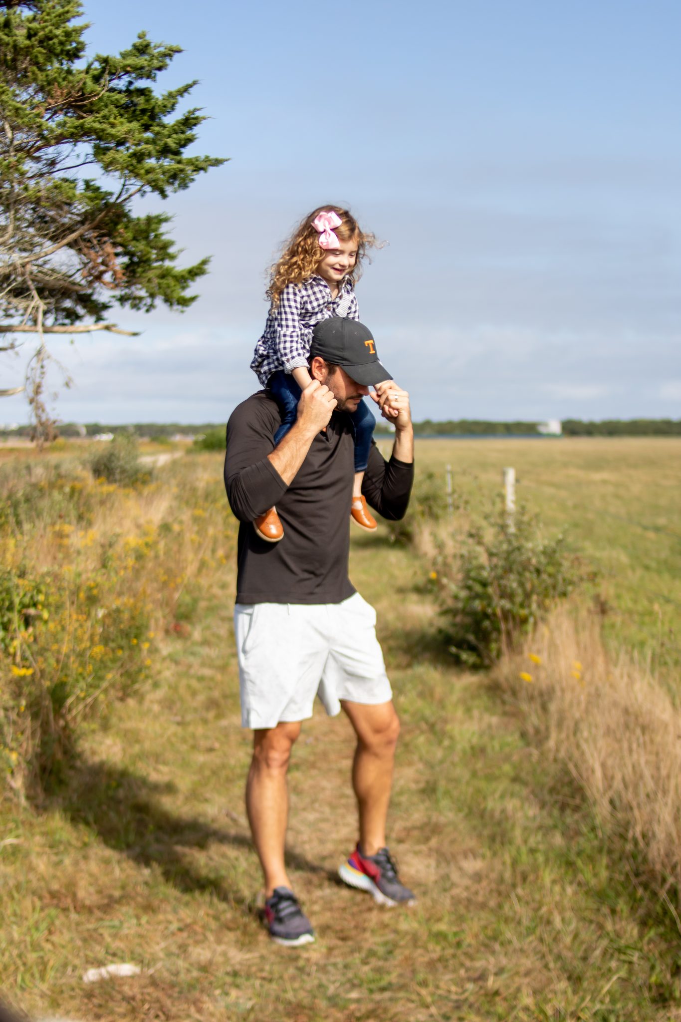 little girl on dad's shoulders at Katama Airfield