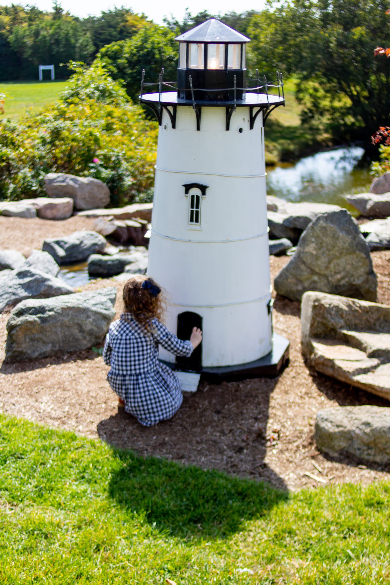 Little girl knocking on door of lighthouse at Winnetu
