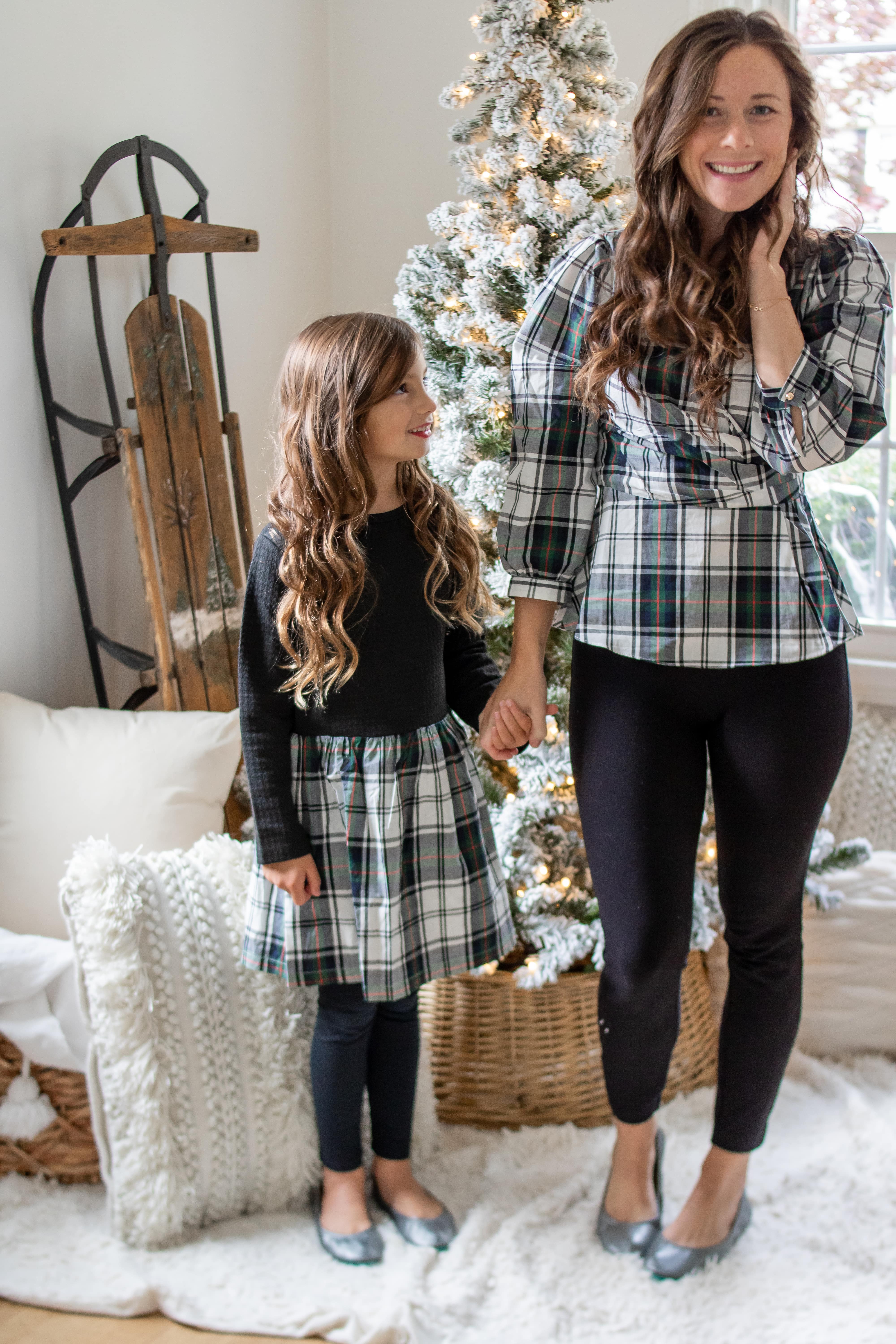 little girl with at mom wearing matching black plaid outfits and Tieks