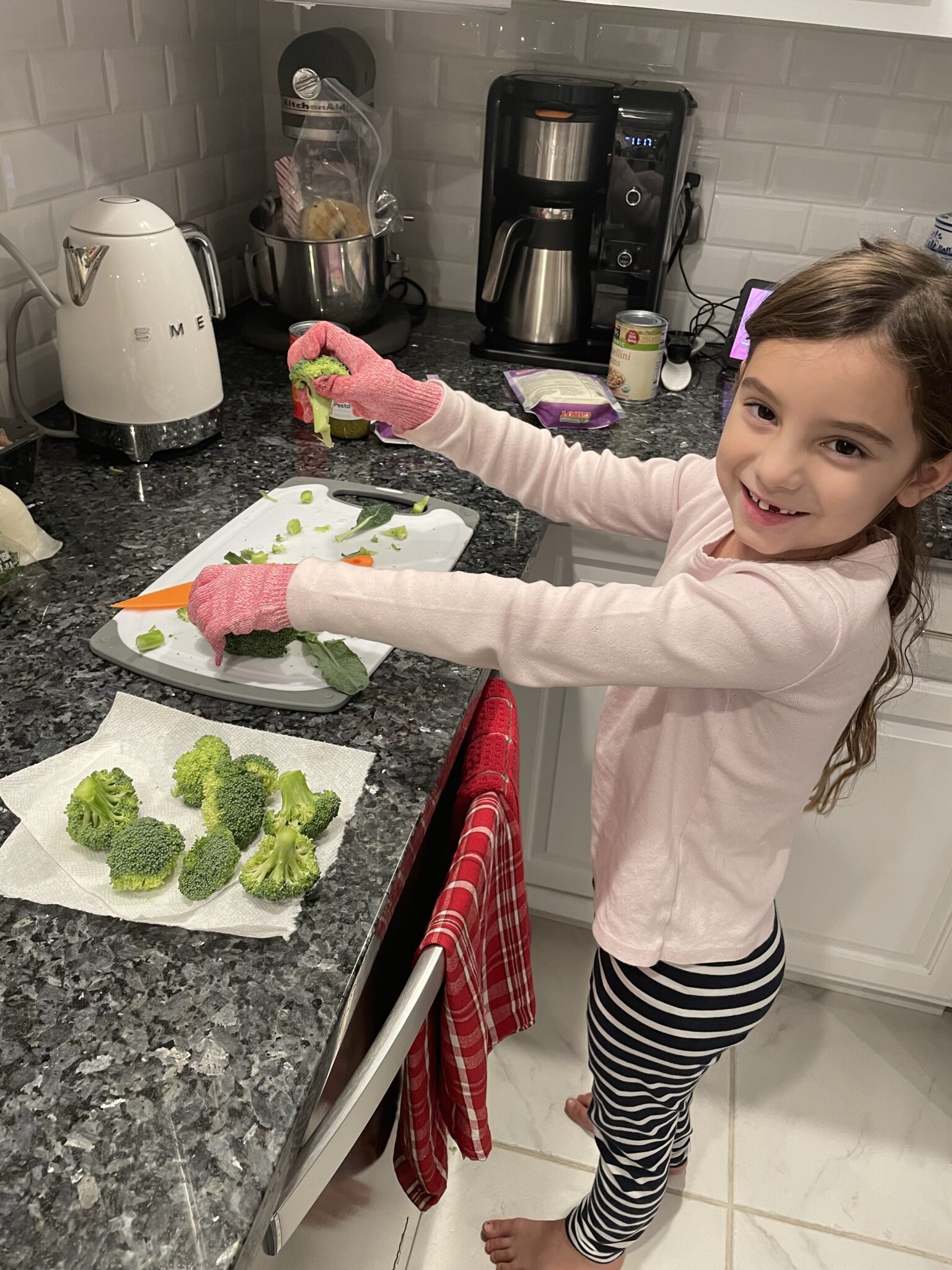 little girl using knife to help in the kitchen