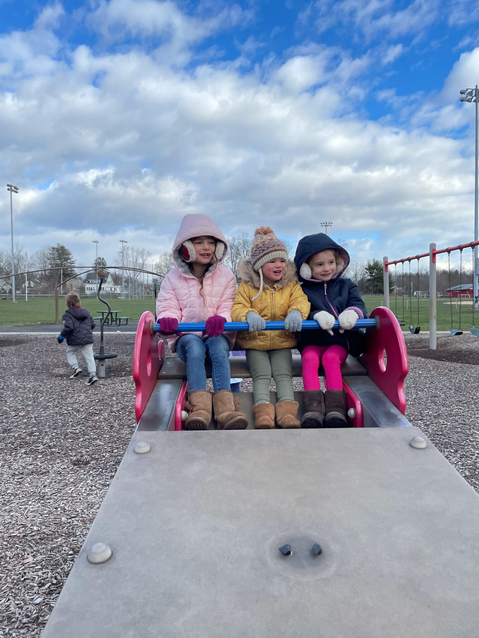 little girls on seesaw at park