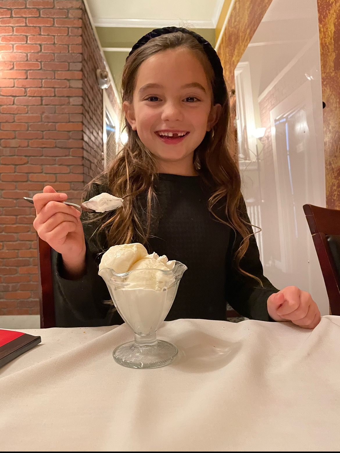 little girl eating vanilla ice cream