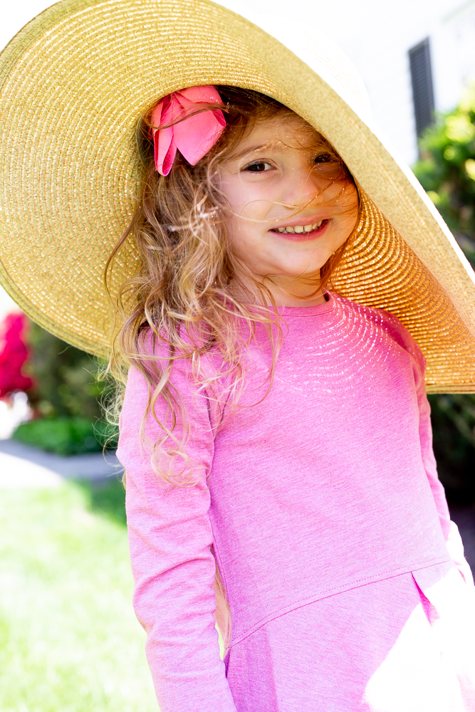 little girl in sun safe hat and shirt coolibar