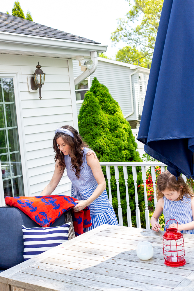 Mom and daughters decorating porch for Memorial Day and summer entertaining