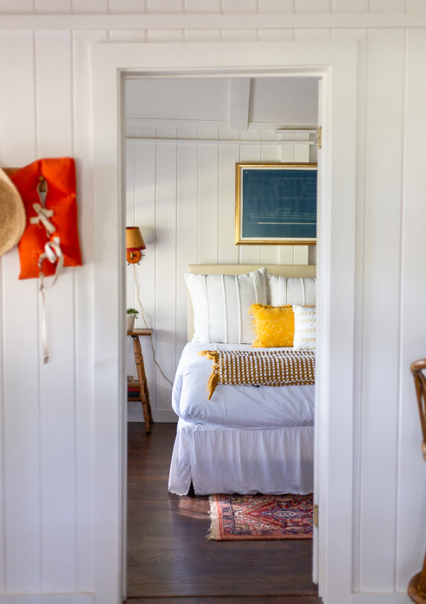 cottage bedroom with coastal Maine inspired decor yellow and red nautical accents