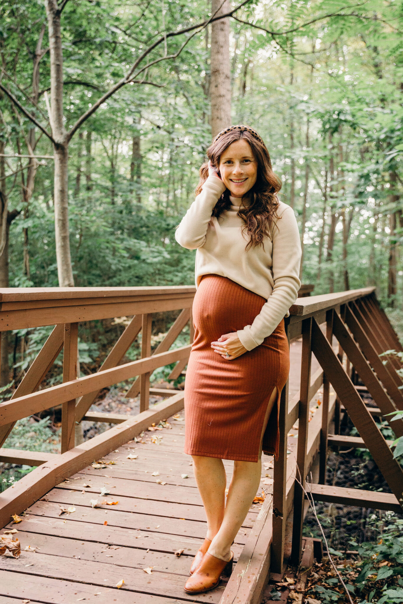 shirt tucked in bra above baby bump with pencil skirt