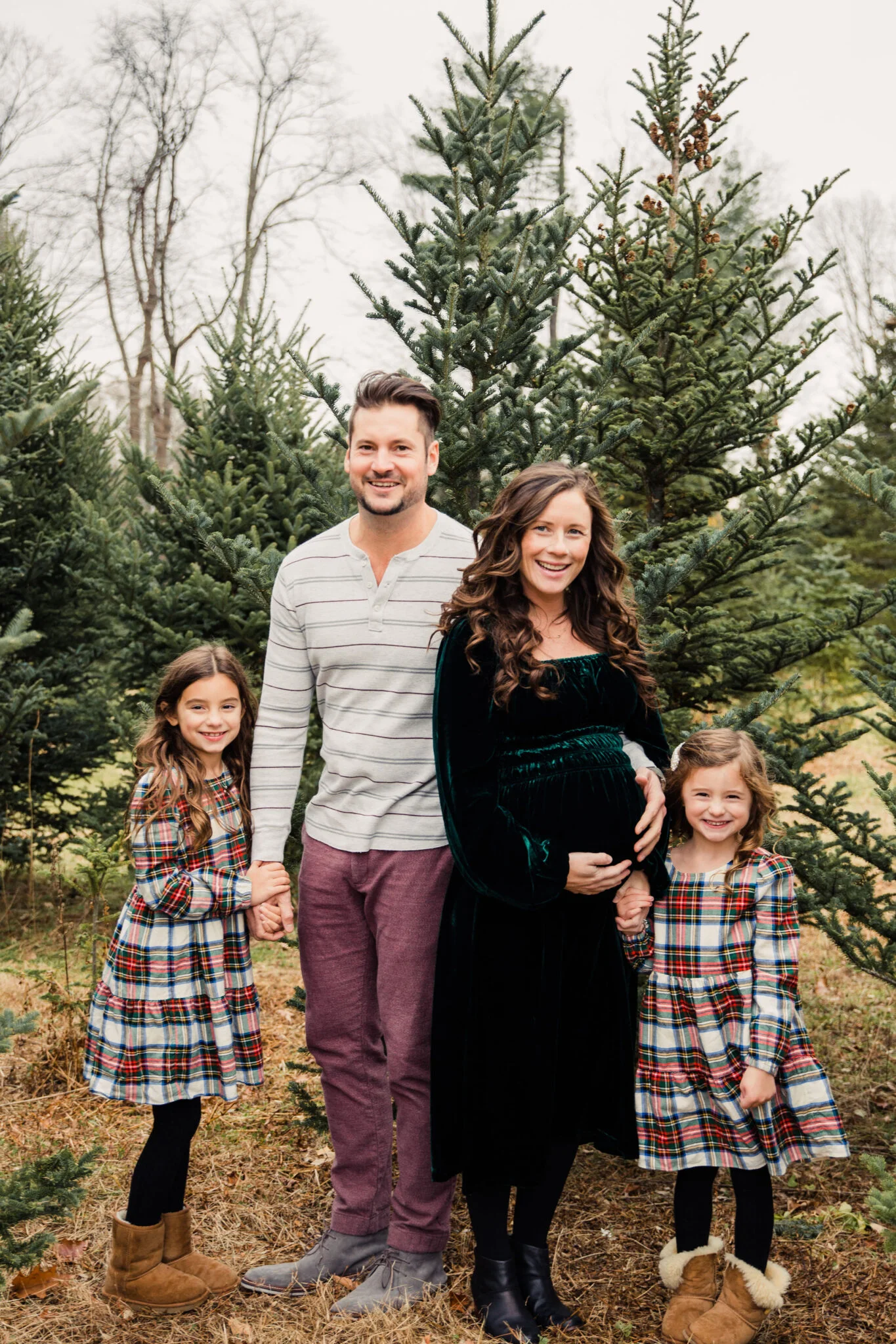 Holiday Photo with Pregnant Mom in Hillhouse Green Dress two daughters in plaid Jcrew and husband in maroon 
