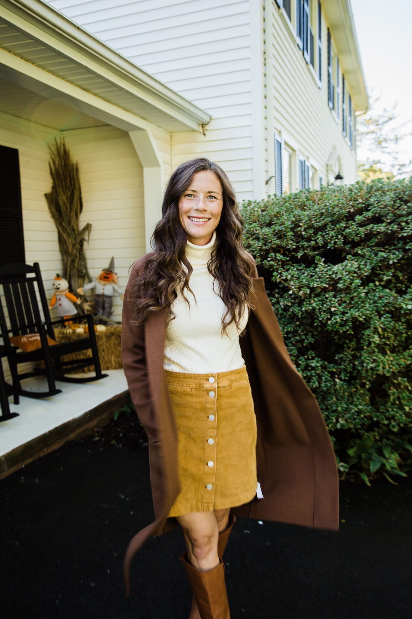 brown sweater cardigan with turtleneck corduroy skirt and riding boots