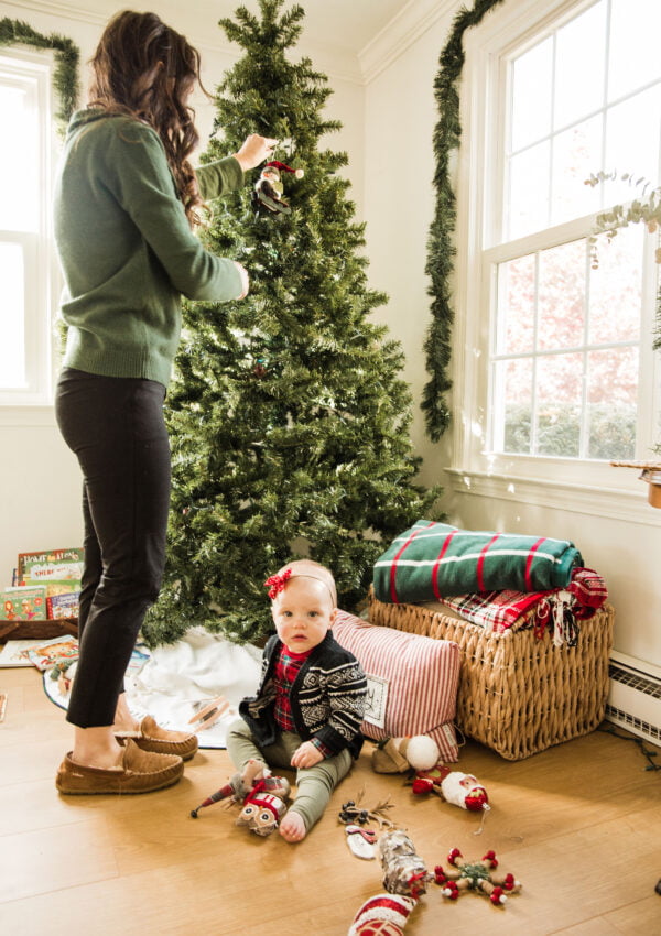 Mom with baby at feet Christmas tree