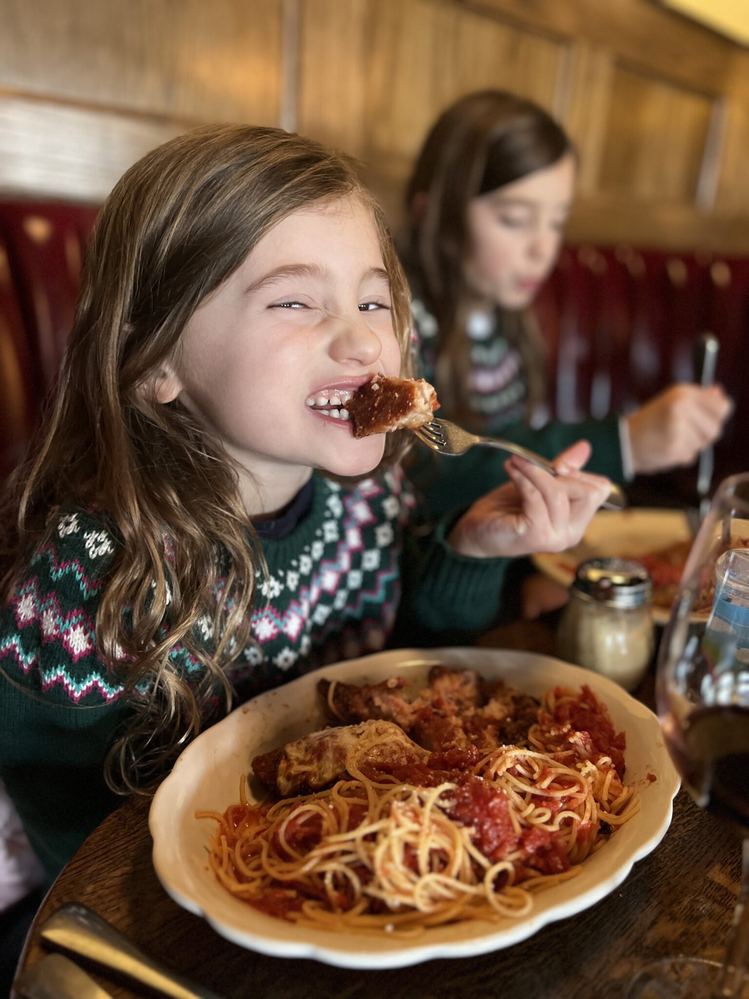 Little girl with chicken parmesan at Andiamo Mystic