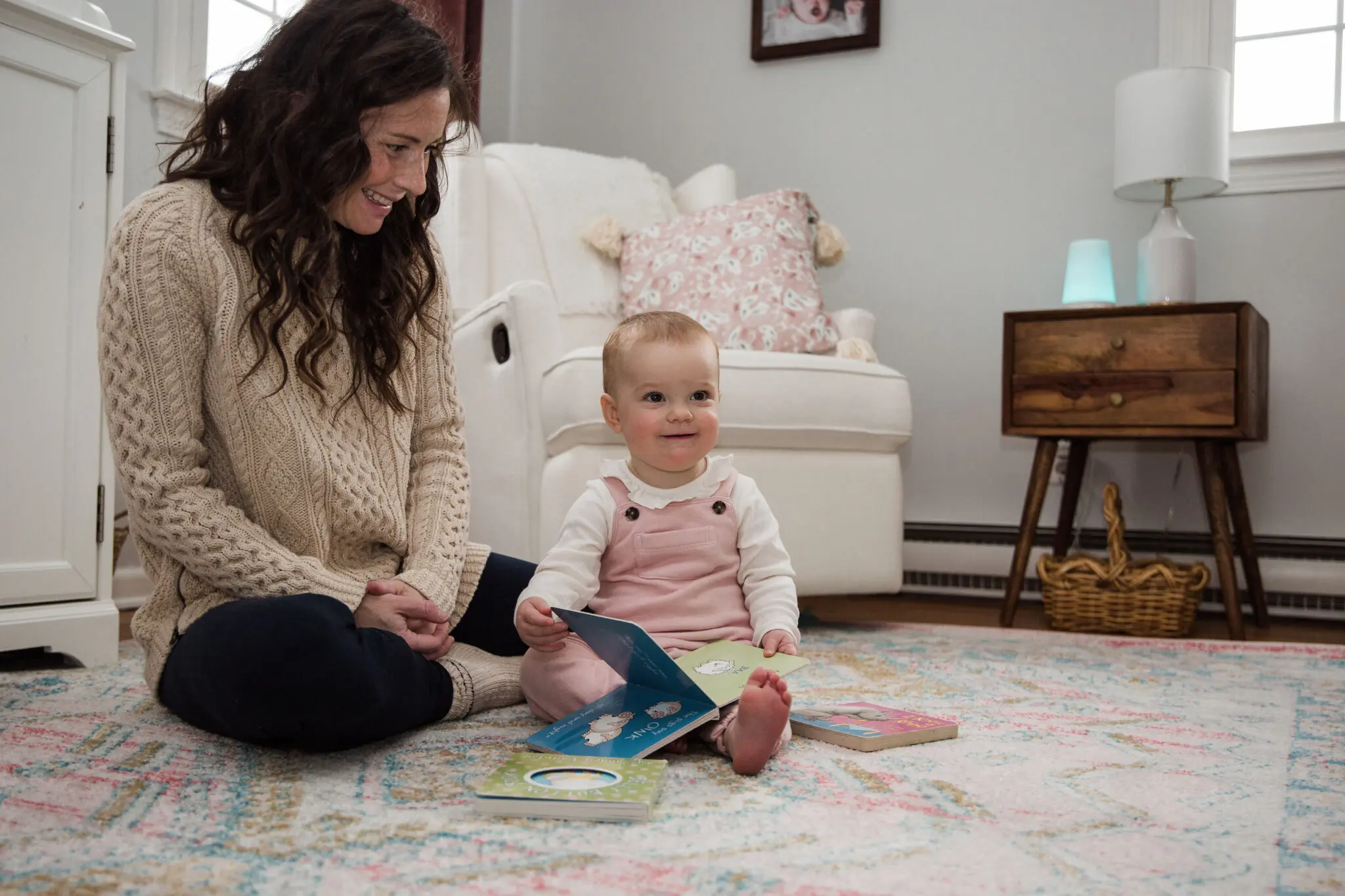 Mom and Baby sitting on rug in nursery