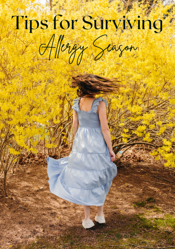 Woman twirling in front of yellow bush surviving allergy season