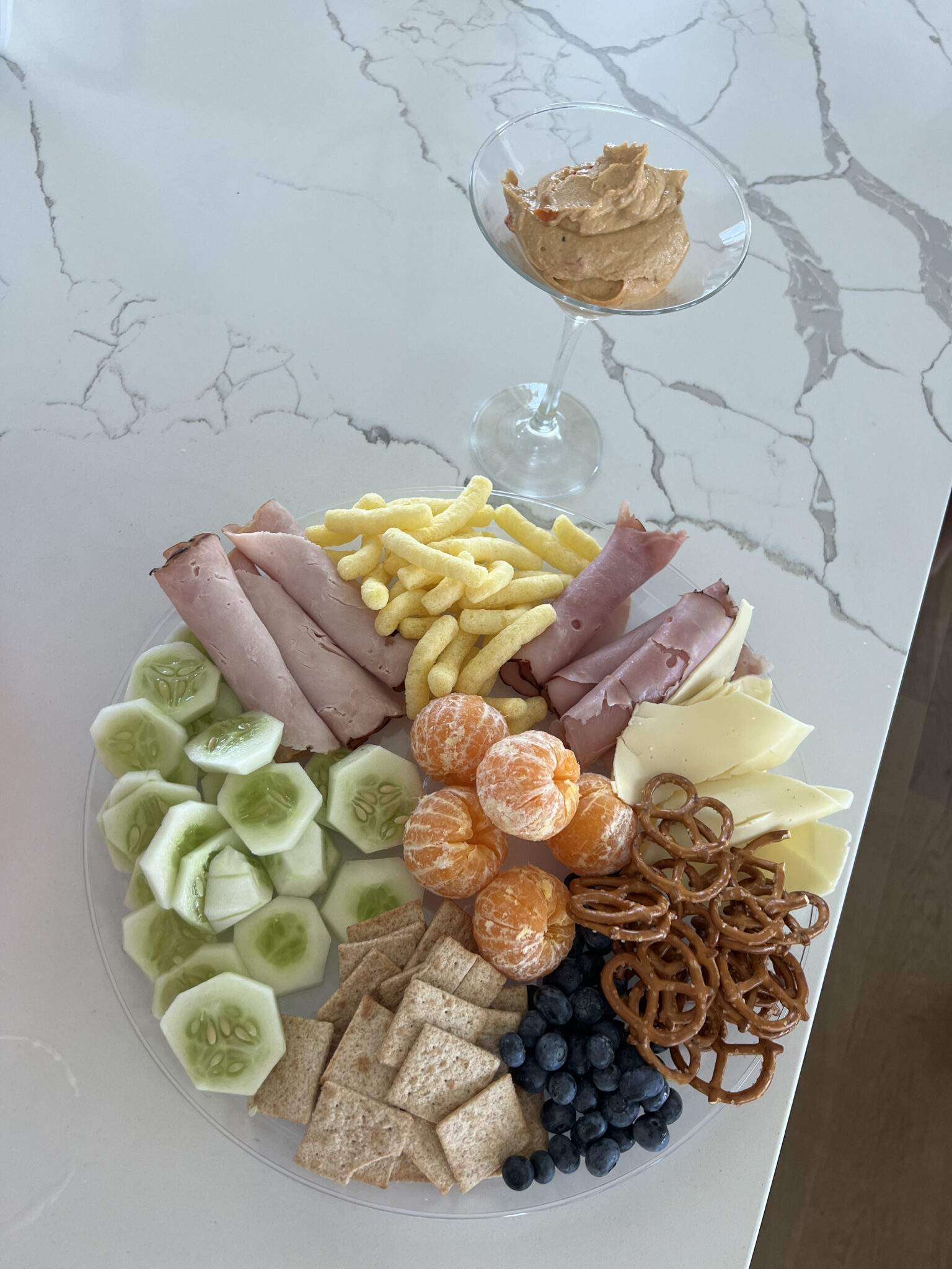 Kids Charcuterie Plate with deli meat, cheetos, cheese, pretzels, fruit, hummus for large family snack idea on vacation