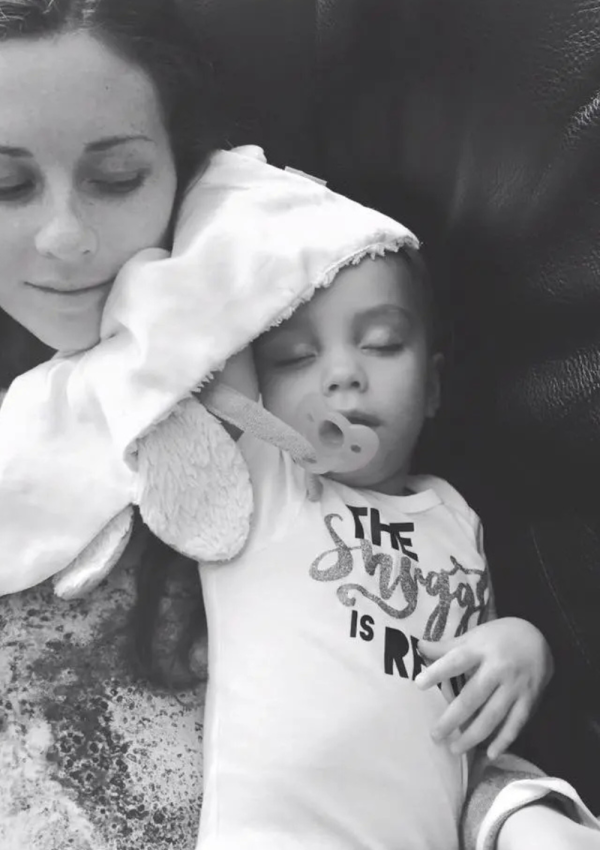 Postpartum Mom with Toddler laying on her talks about Postpartum depression after weaning from breastfeeding