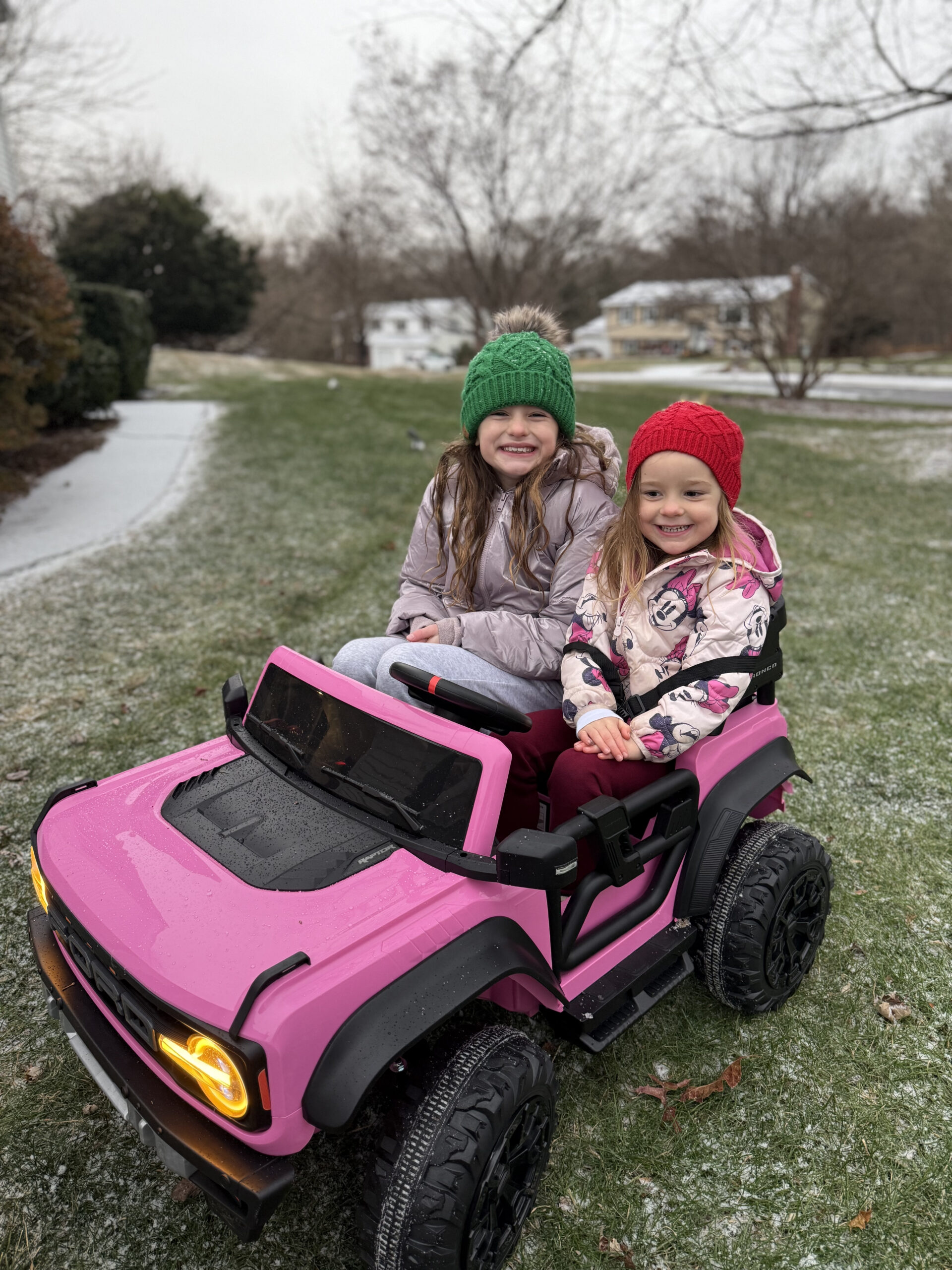 sisters riding in jeep in snow