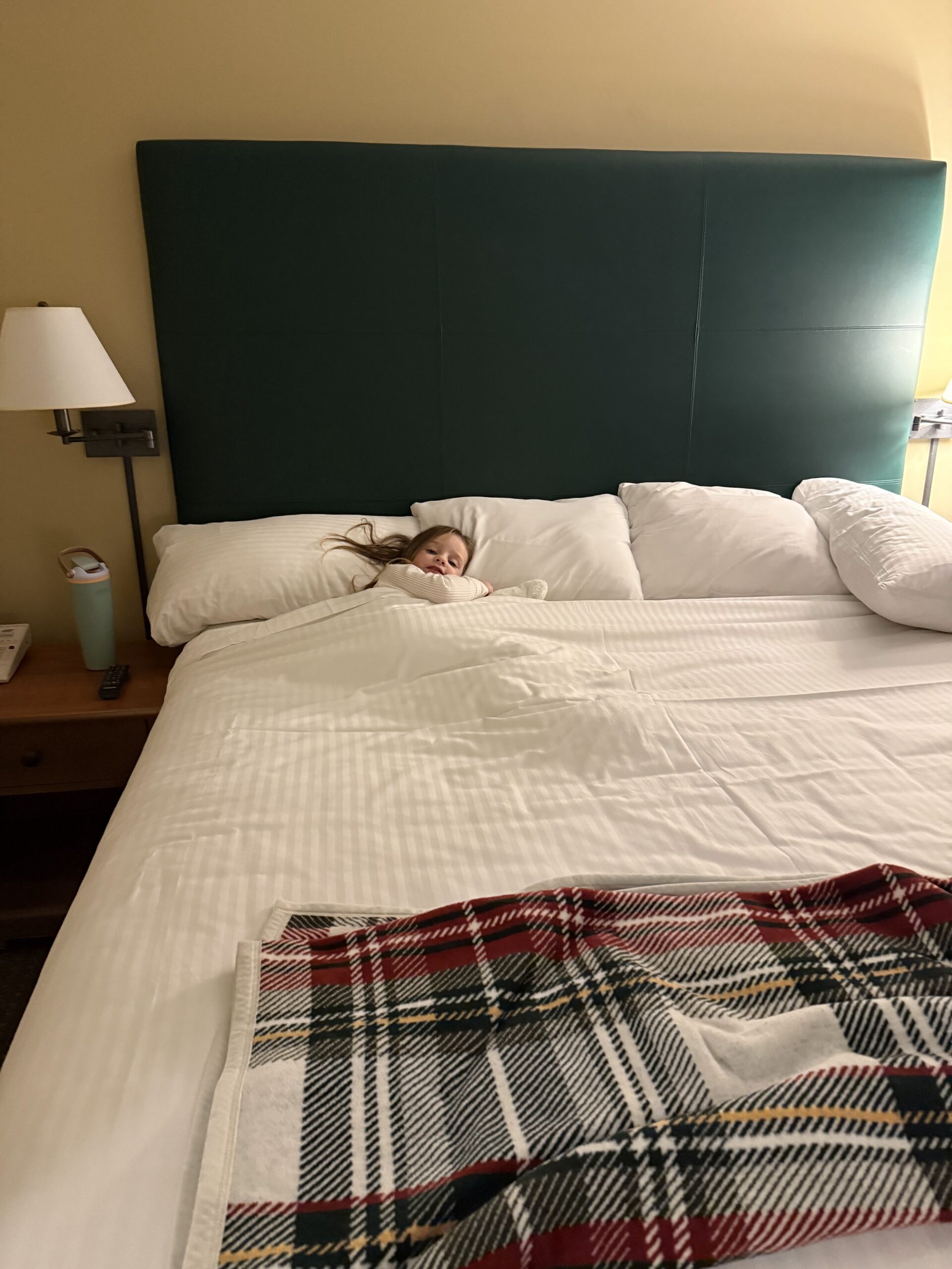 Toddler laying in Grand Summit Resort Mount Snow King Bed