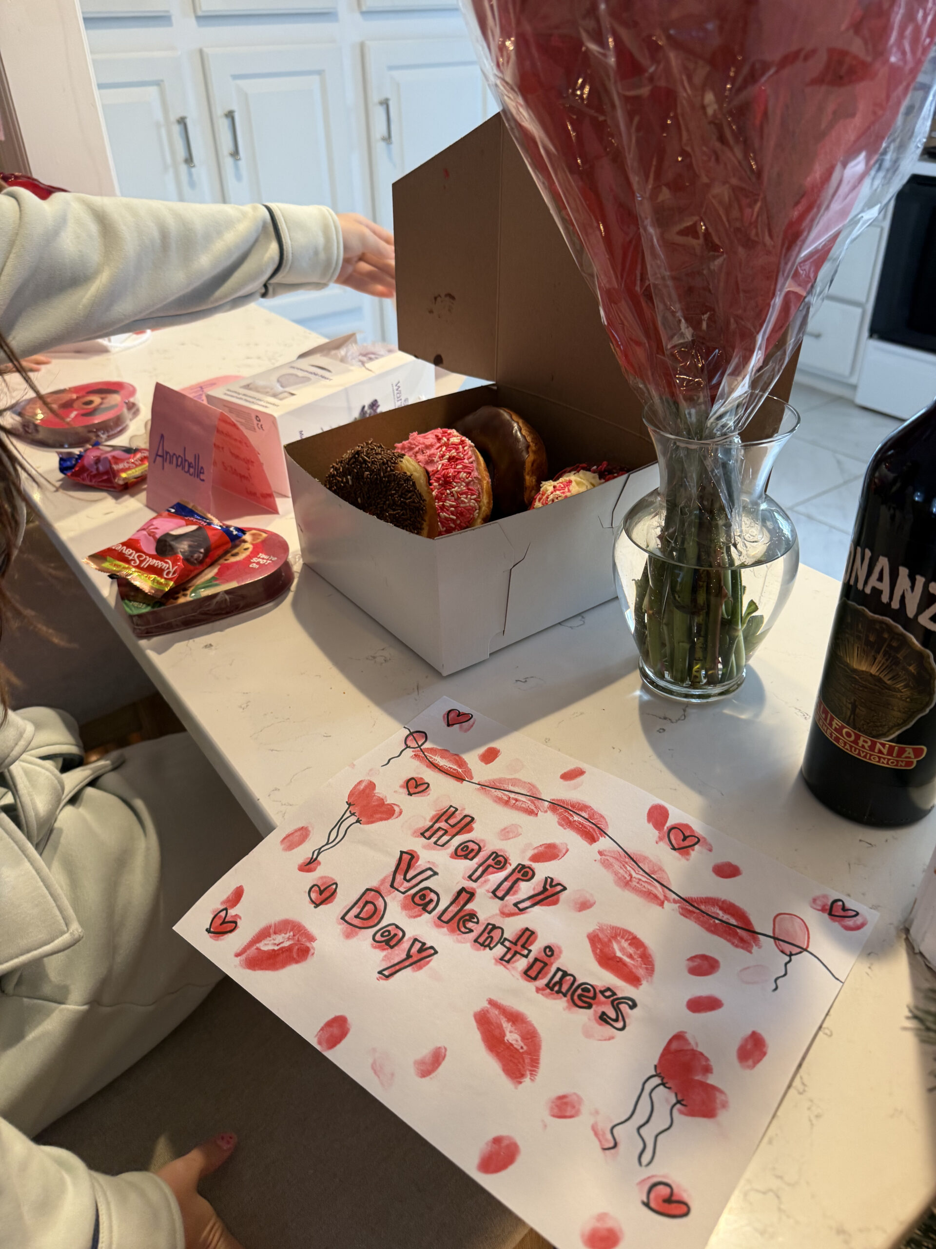 Valentine's Day donuts, homemade card with kisses, and gifts