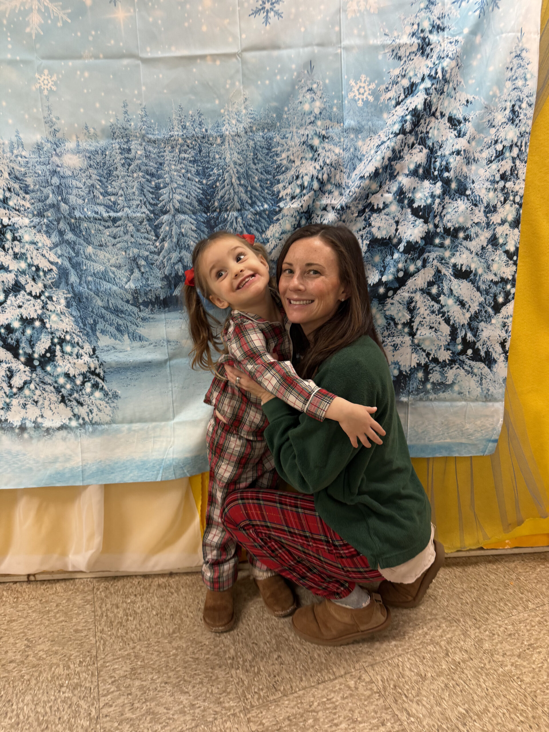 mom and toddler hugging pajamas christmas preschool party