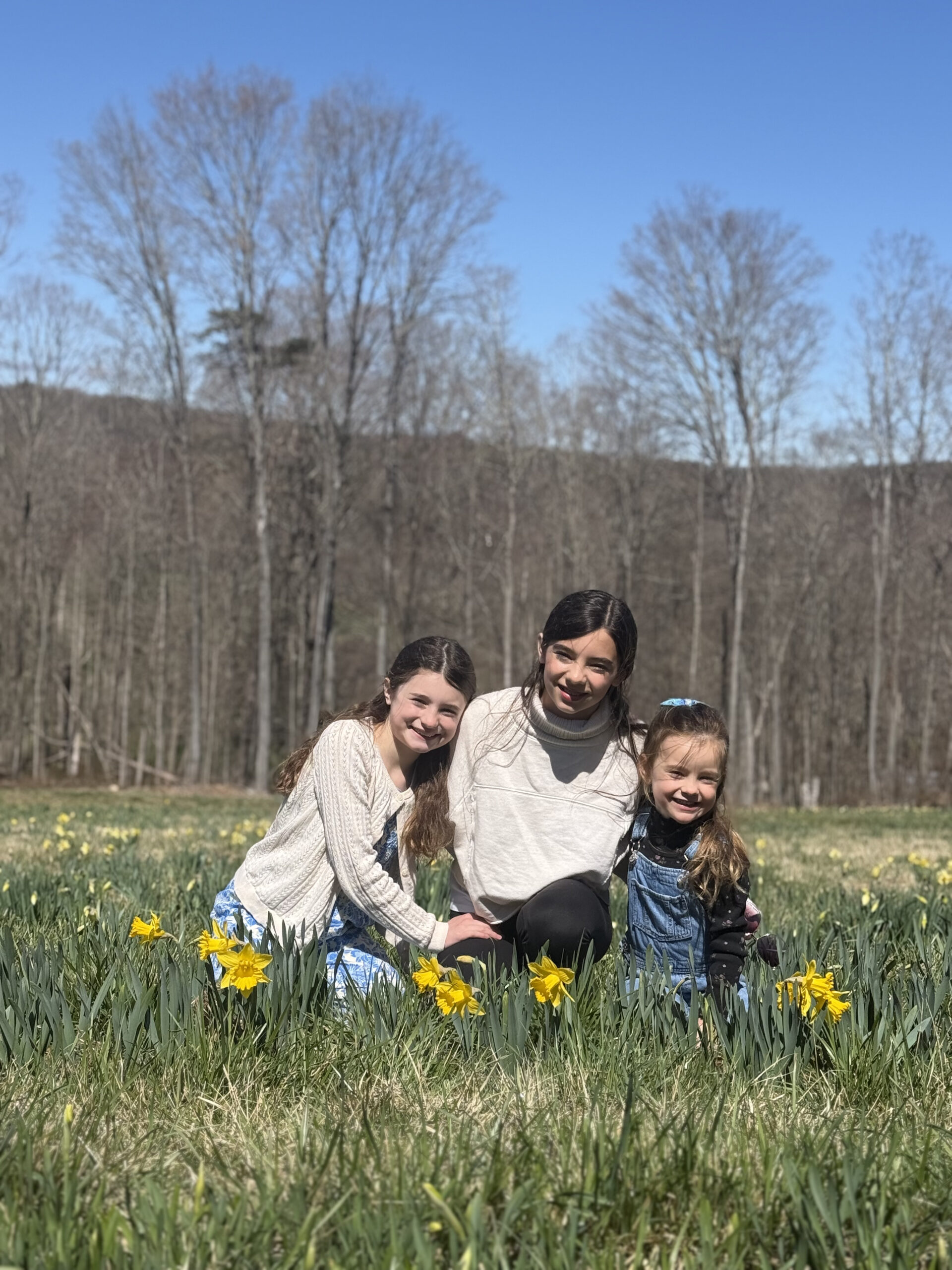 sisters in daffodil field 